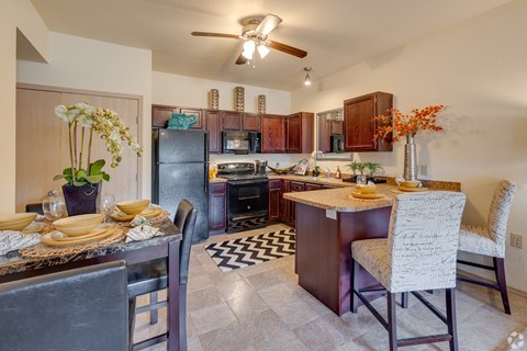 a kitchen and dining area with a dining table and chairs