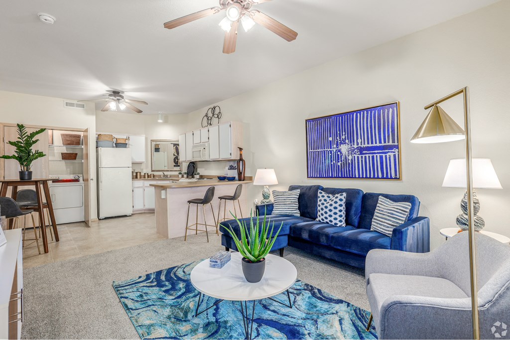 a living room with a blue couch and a coffee table