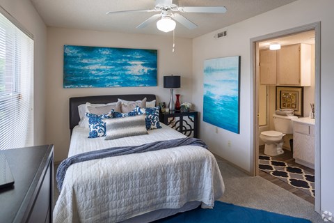 a bedroom with a bed and a ceiling fan