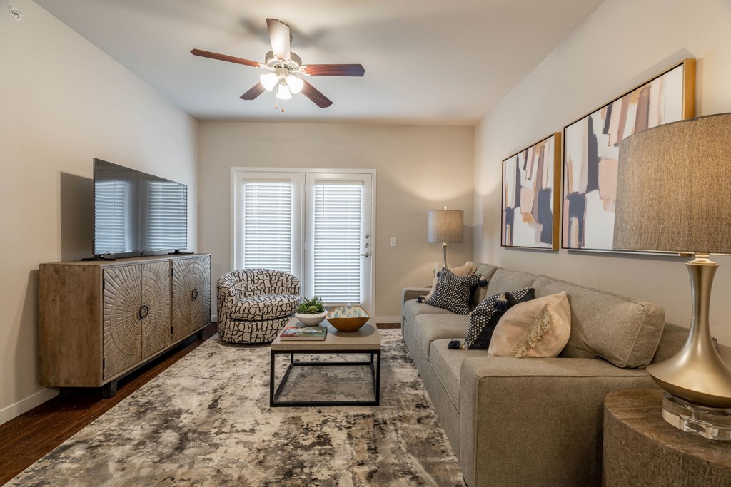 a living room with a couch and a ceiling fan