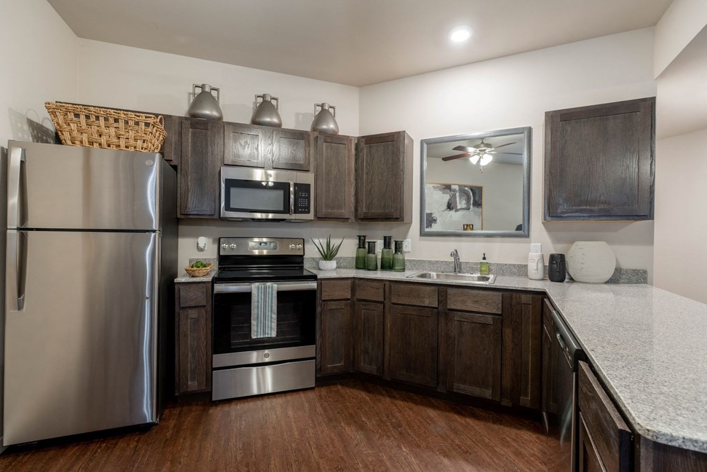 a kitchen with stainless steel appliances and wooden cabinets