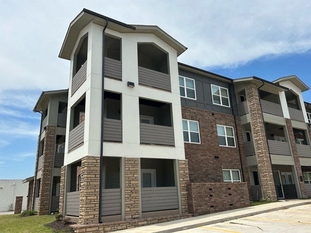 a picture of a apartment building with a blue sky in the background