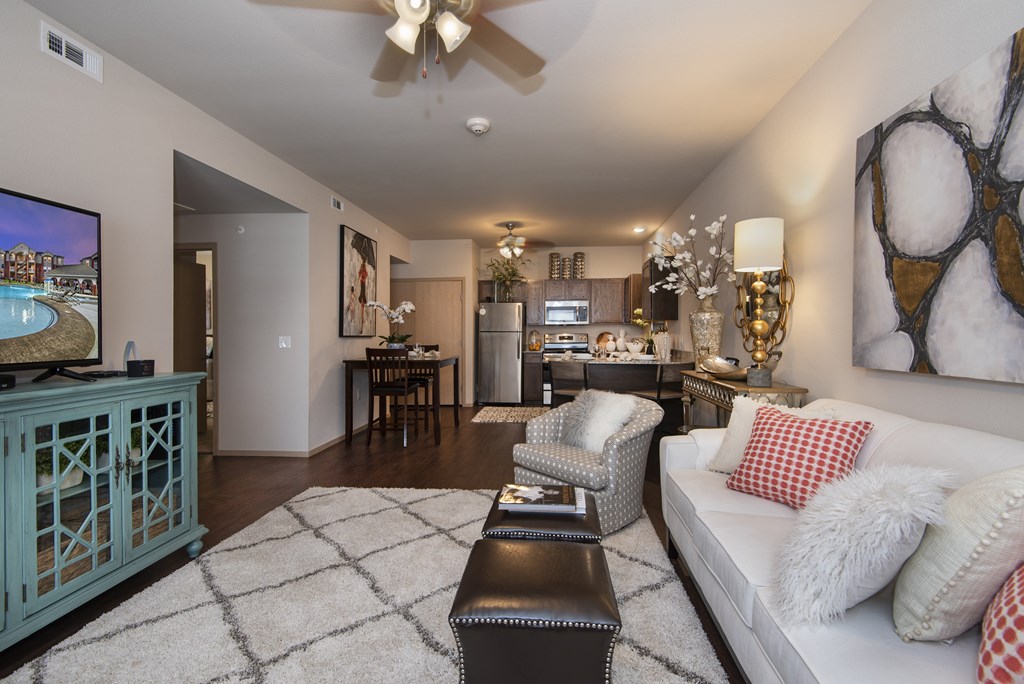 A living room with a white couch and a television.