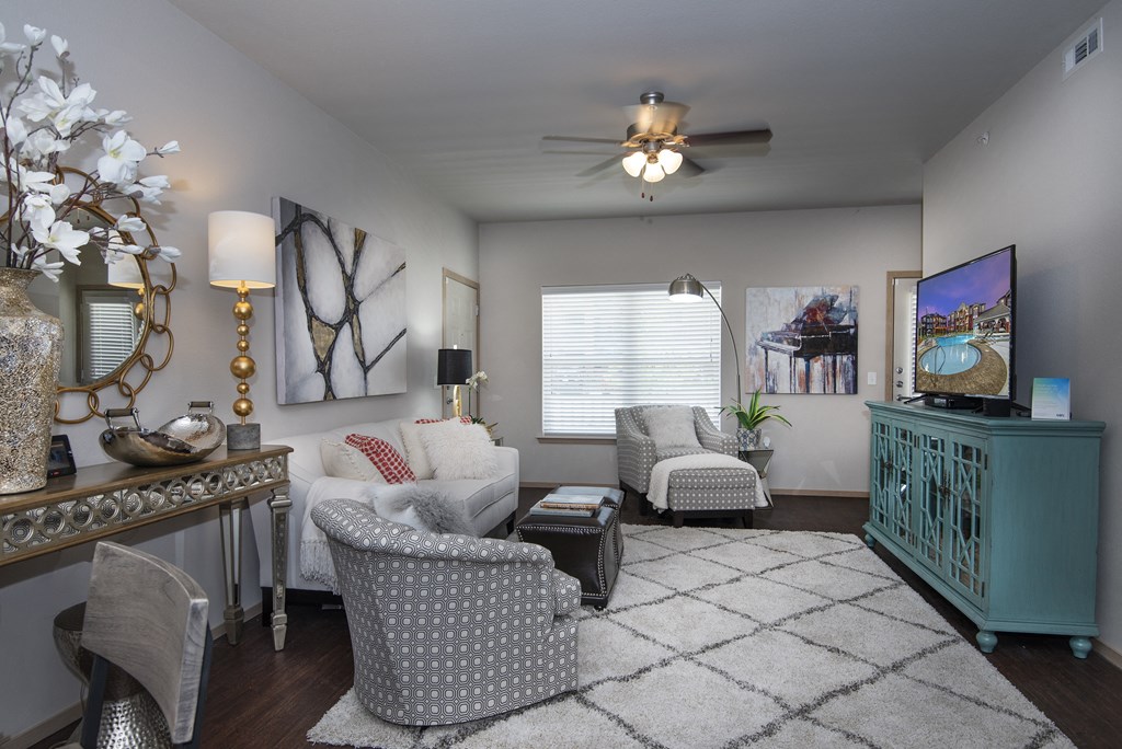 A living room with a grey patterned chair in the center.