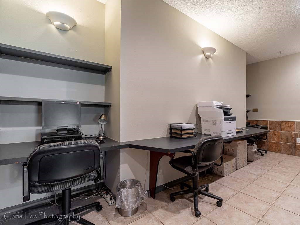 a office with two desks and a printer