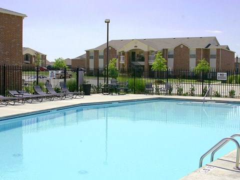 a swimming pool in front of an apartment building