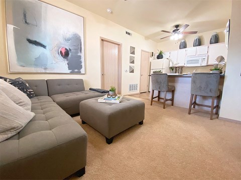 a living room and kitchen with a couch and a table