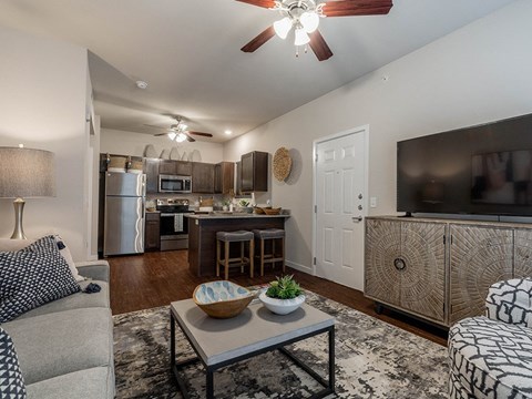 A modern kitchen with a dining area and a living room.