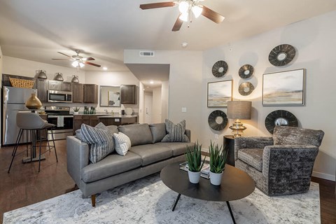 A living room with a grey couch and a coffee table.