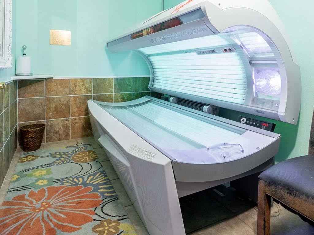 a patient exam room with a patient bed and a radiation machine