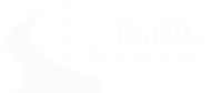 A logo with the text "The Trails at the Crossings" in white on a black background.