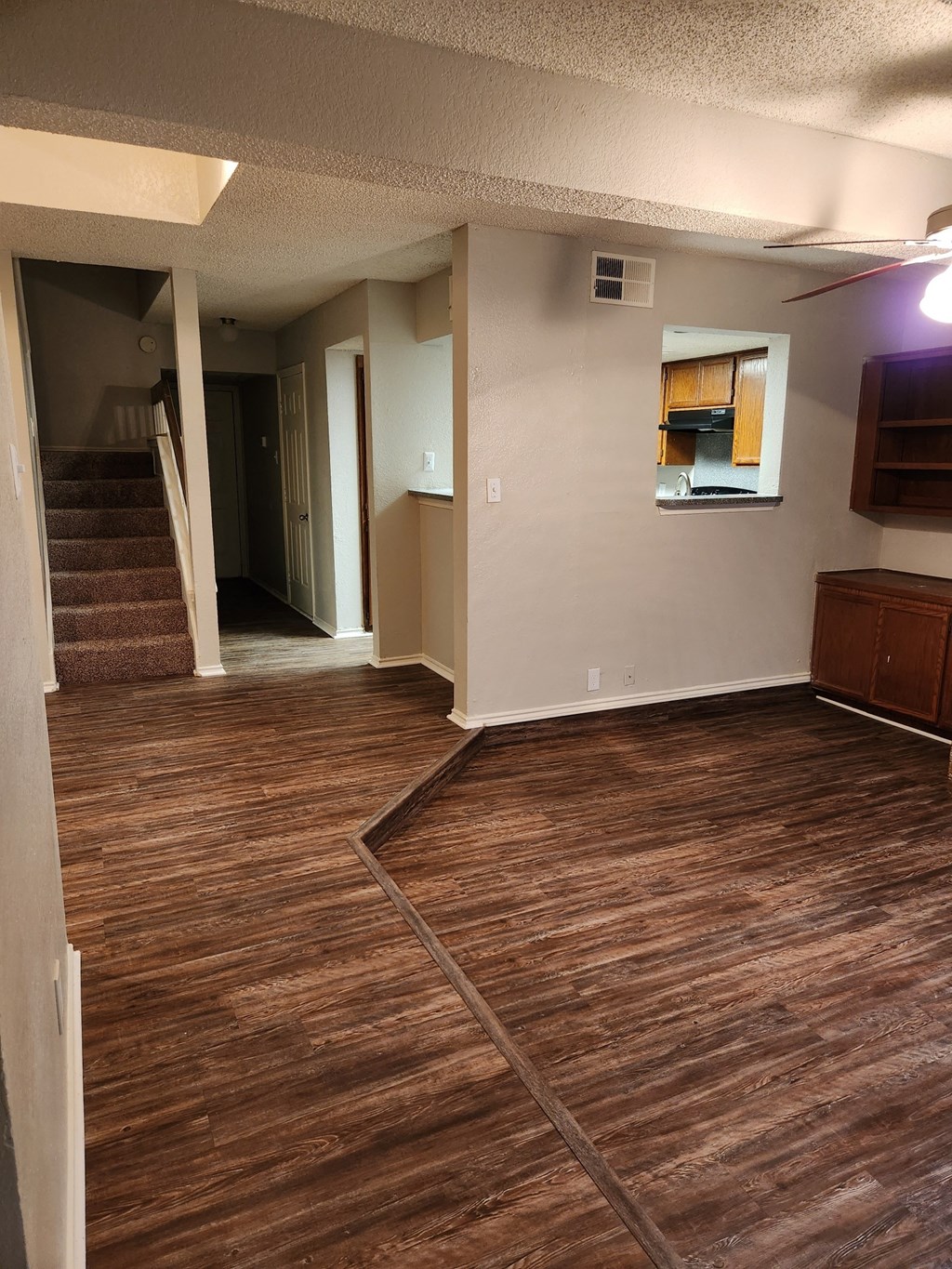 Delmar Villas Spacious Livingrooms with Wood-inspired Vinyl Plank Flooring an empty living room with a hardwood floor