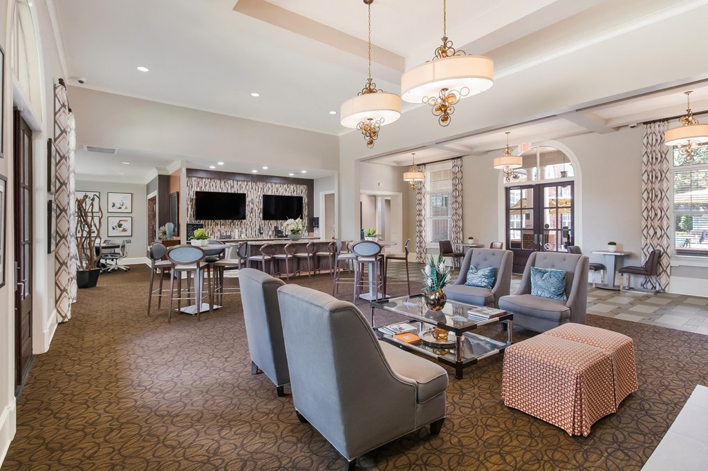 community club house room with couches and chairs and a table