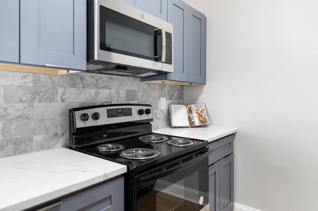 a kitchen with a stove and a microwave