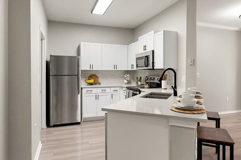 spacious kitchen with stainless steel appliances at the district flats apartments in lenexa