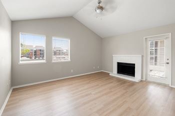 a living room with a fireplace and a wooden floor