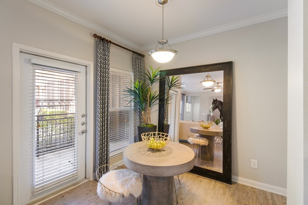 a dining room with a large mirror and a window