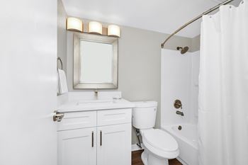 a bathroom with a shower and a sink and a toilet