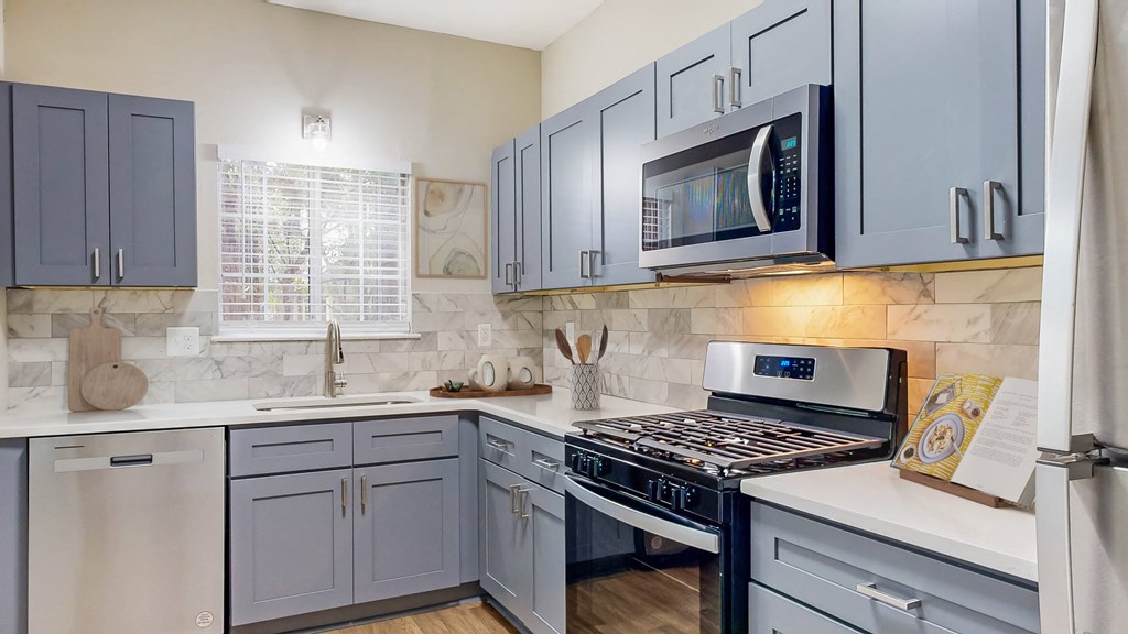 Remodeled kitchen with gas stove and a microwave