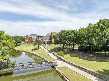 a bridge over a body of water next to some trees
