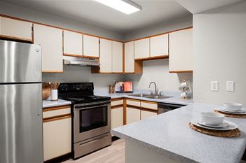 a kitchen with stainless steel appliances and white cabinets