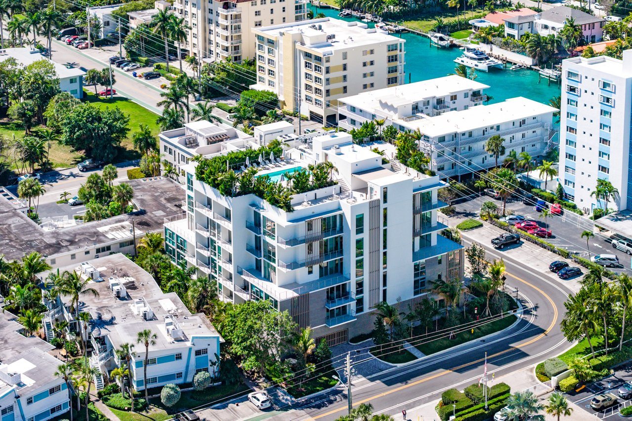 A view of a residential area with apartment buildings and a roundabout.