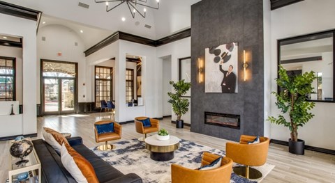 A modern living room with a fireplace and a large painting on the wall.