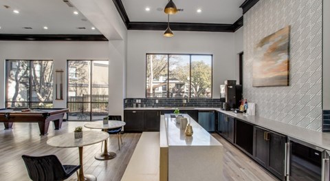 A modern kitchen with a dining table and chairs.