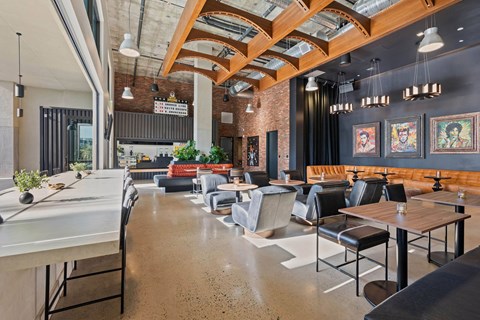 Clubhouse lounge with curved wood beam ceiling at AMP 30 Apartments, San Diego, CA