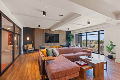 A living room with a couch, a chair, a coffee table and a television.