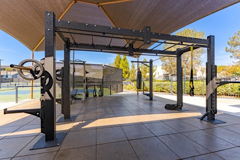 A gym with a pull up bar and a bench.