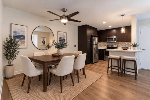 A modern dining room with a wooden table and chairs.