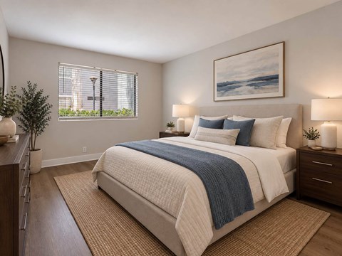 A bedroom with a large bed and a painting on the wall.