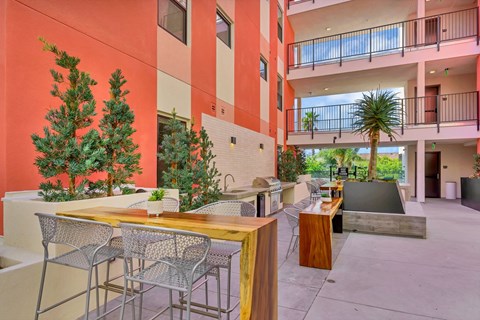 Open air courtyard with communal kitchen and dining at EVOC Apartments, San Diego, California