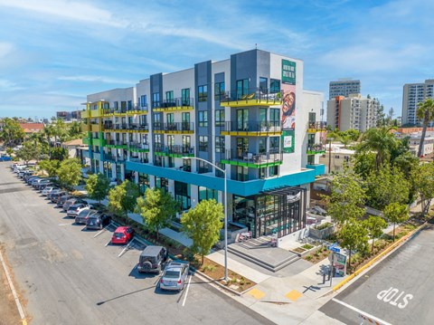 Aerial view of colorful modern building exterior at EVOC Apartments, San Diego, California