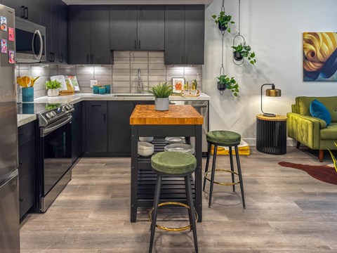 A kitchen with a table and chairs in the middle of it.