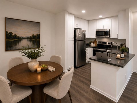 Dining area with kitchen and white cabinetry at River Front Apartments, California, 92108