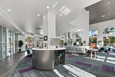 A modern office space with a reception desk and seating areas.