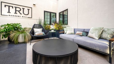 Outdoor courtyard seating with contemporary furnishings at TRU Bankers Hill Apartments, San Diego, CA