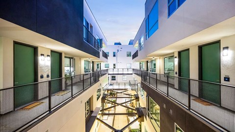 A modern building with a balcony and a playground.