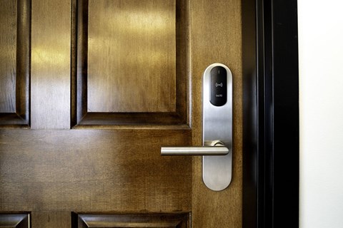 A modern door handle with a digital lock.