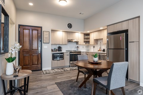 A modern kitchen with a dining table and chairs.