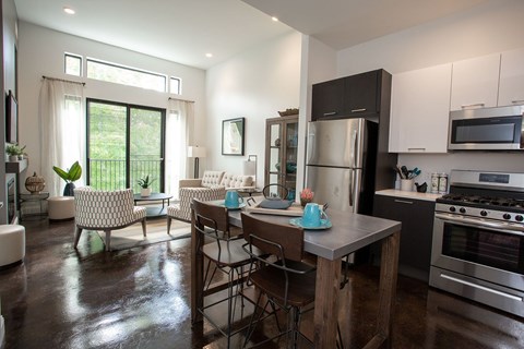 A modern kitchen with a dining table and chairs.