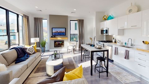 A modern living room with a grey sofa and a television.