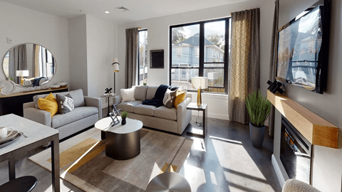 Contemporary living room with large windows at 22 & 28 Mechanic Street Apartments, Quincy, MA