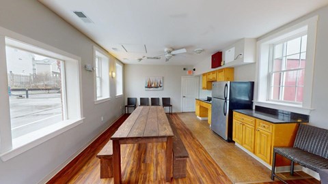 A kitchen with a wooden table and benches.
