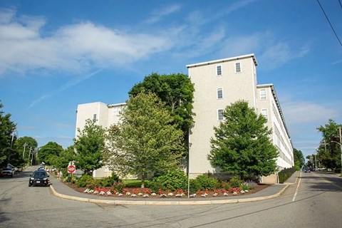 Exterior view of main building with landscaping at Emerson Shoe Lofts Apartments, Rockland, 02370