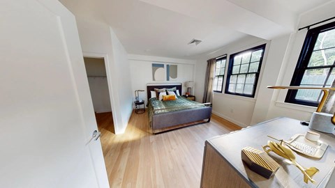 Spacious bedroom with wood flooring and dual windows at The Overlook Apartments, Weymouth, MA