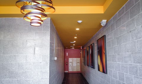 Residential hallway with spiral chandelier and mailboxes at 68 Beale Apartments, Quincy, Massachusetts