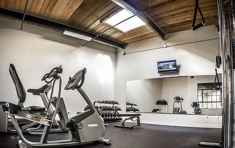 Fitness center with cardio and weight equipment at Star Mill Lofts Apartments, Massachusetts
